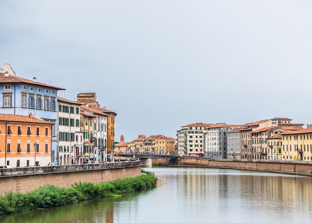 Cloudy landscape with a view of the Arno river in Pisa. Travel Italy concept