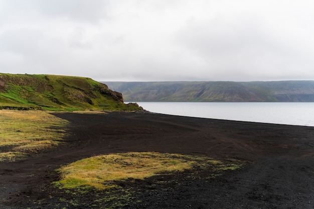 Cloudy nature landscape by lake