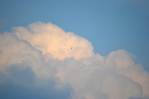 Cloudy sky plane in a distance