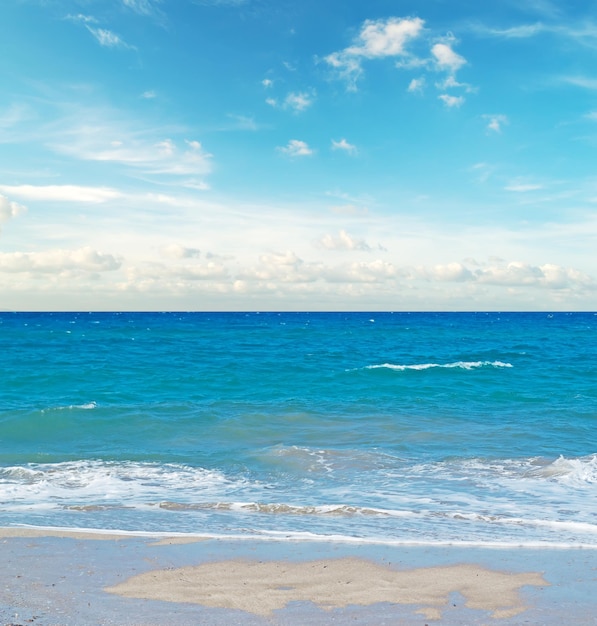 Cloudy sky over a white sandy beach