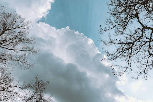 Cloudy sky with autumn or spring thunderclouds, glimpses of sun's rays through clouds