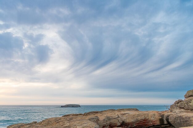 Cloudy sky with beach cliff and ocean nature