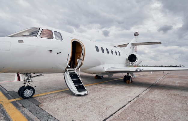 Cloudy weather Turboprop aircraft parked on the runway at daytime