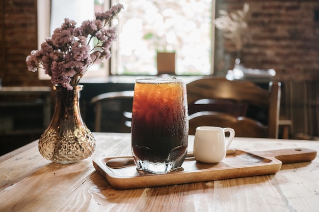 clouse up fresh ice coffee (cold americano) in coffee shop background.