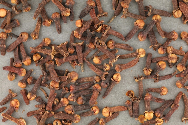 Clove spice heap on a gray background