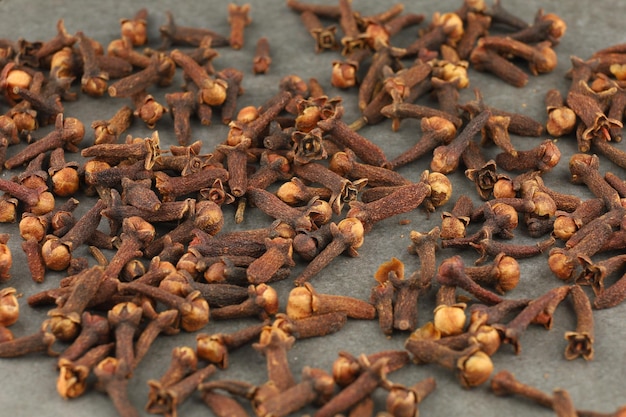 Clove spice heap on a gray background