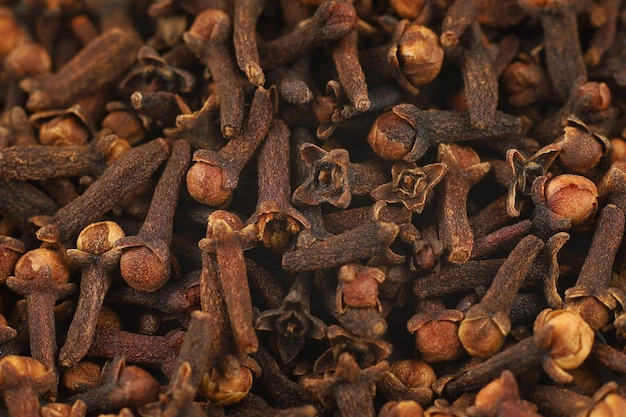 Clove spice pile close up Dry spice cloves background and texture top view