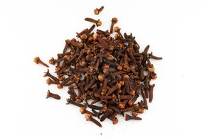 clove spice pile on white isolate