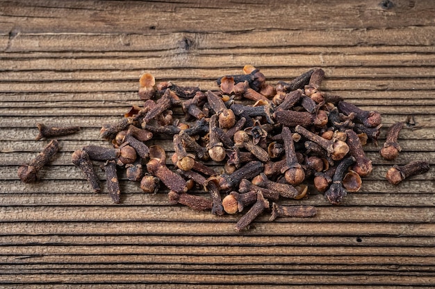 Clove spice on a wooden board Syzygium aromaticum