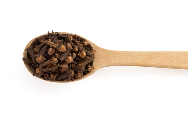 clove spices and spoon isolated on white