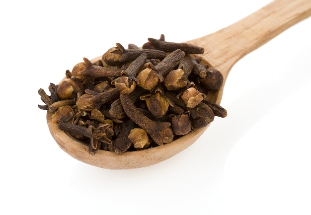 clove spices in spoon on white
