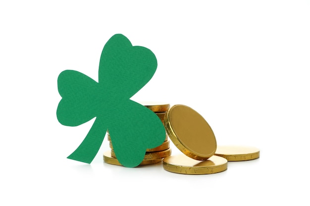 Clover leaf and chocolate coins isolated on white background