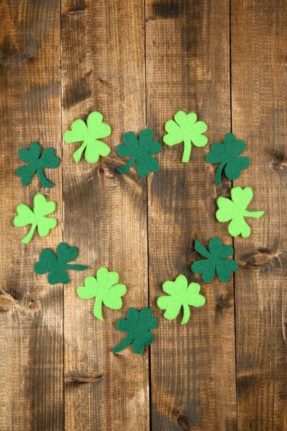 Clover leaves on wooden background