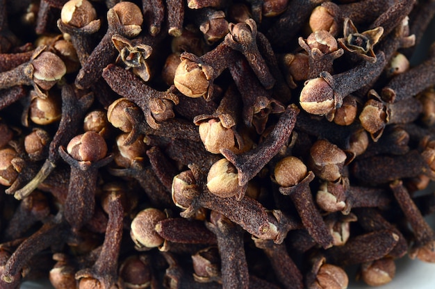 Cloves in plate isolated on white background