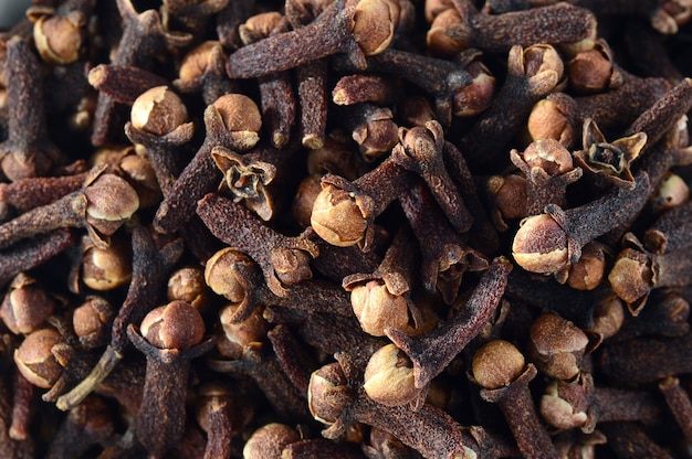 Cloves in plate isolated on white background