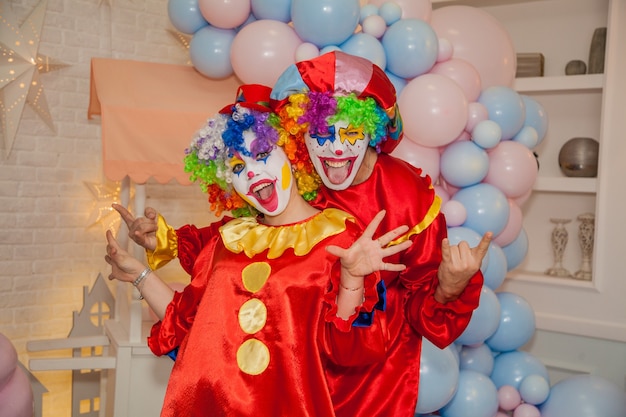Clown boy and clown girl at the childs birthday Fun and emotions