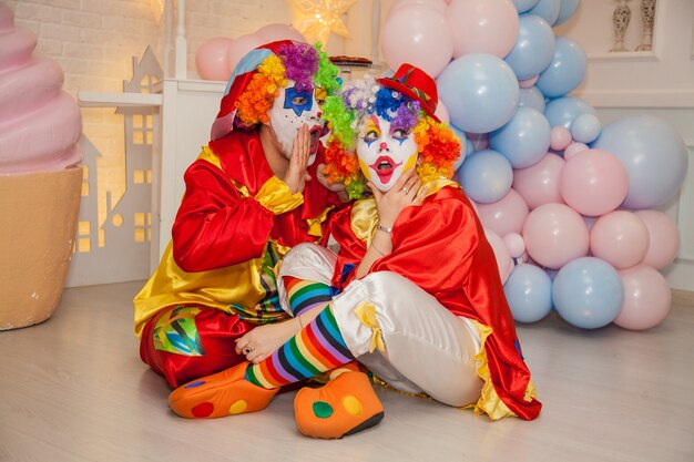 Clown boy with clown girl having fun at the holiday