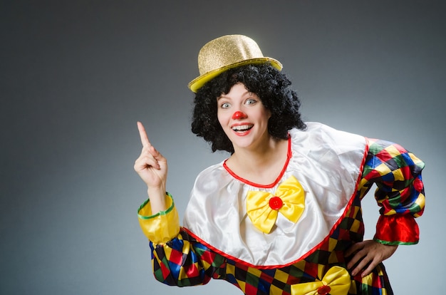 Clown in funny concept on dark background