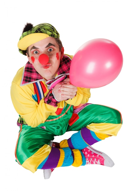 Photo clown with a balloon in a hand isolated on the white background