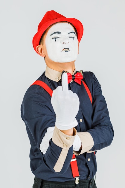 Photo clown with red suspenders and red hat on white background