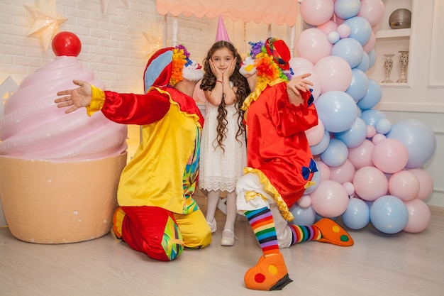 Clownjongen en clownmeisje op de meisjesverjaardag Plezier en genotzucht