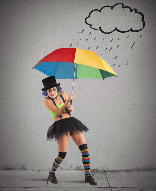 Foto pagliacci con ombrello arcobaleno