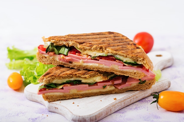 Club sandwich panini with ham, tomato, cheese and lettuce