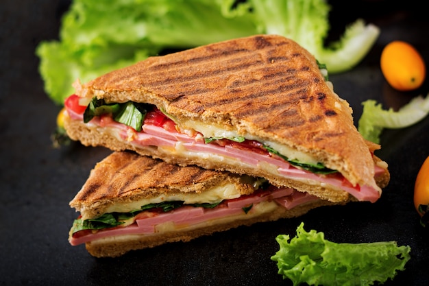 Club sandwich panini with ham, tomato, cheese and lettuce