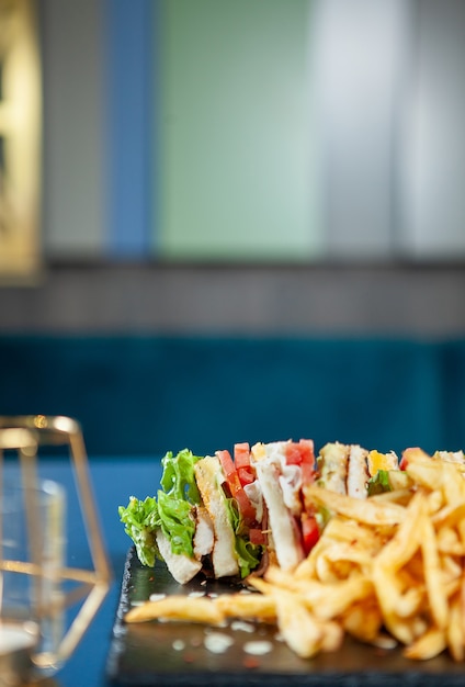 Club sandwich with french fries with pepper sos .fast cuisine