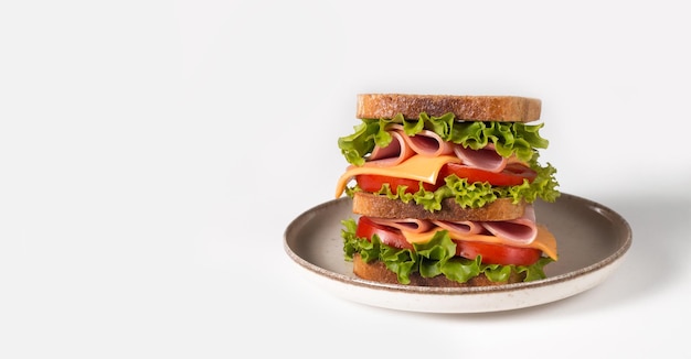 Club sandwich with ham, cheese, tomato and lettuce.