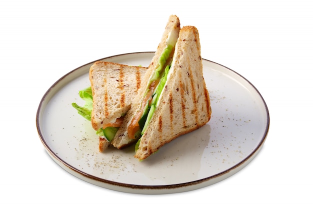 Club sandwich with salmon, cucumber, salad and cheese isolated on white