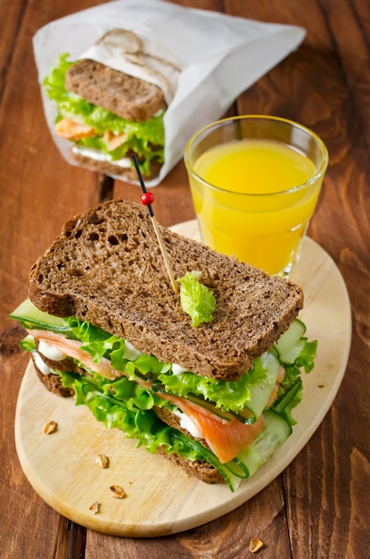 Club sandwich with salmon and cucumbers