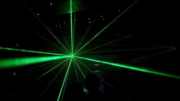 club youth party clip green laser beams on the backlight next to the dj and dancing people