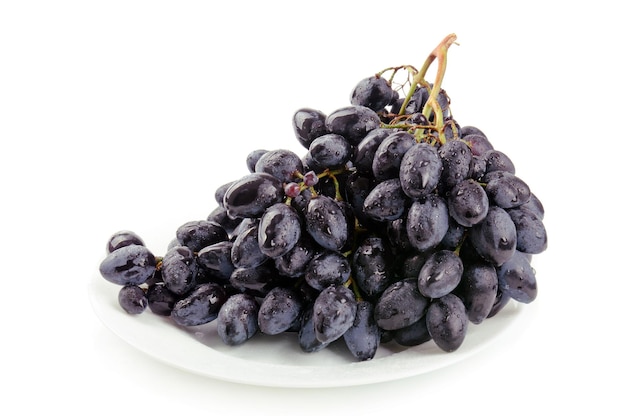 Cluster of fresh grape on the white dish isolated