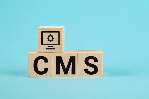 Cms acronym on woodblock cubes blue background frequently asked questions business customer service