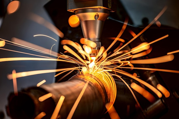 CNC Laser cutting of metal, modern industrial technology Making Industrial Details. The laser optics and CNC (computer numerical control) are used to direct the material or the laser beam generated.