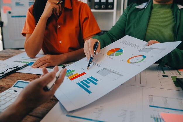 Photo co working conference business team meeting present investor colleagues discussing new plan financial graph data on office table with laptop and digital tablet finance accounting investment