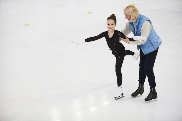 Coach Helping Girl Figure Skating