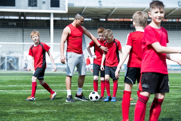 Coach Teaching Football Team