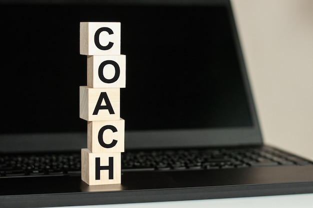 COACH text written on wooden block on computer keyboard. business and Education concept.