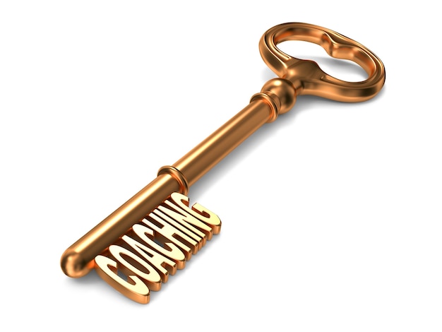 Coaching text on Golden Key on White Background