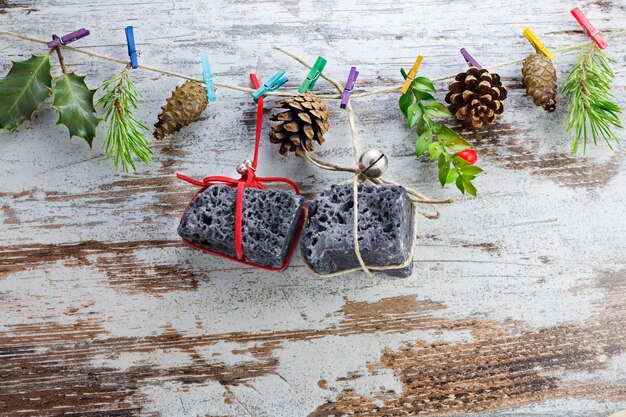 Photo coal christmas gifts hanging in a string with clothespins