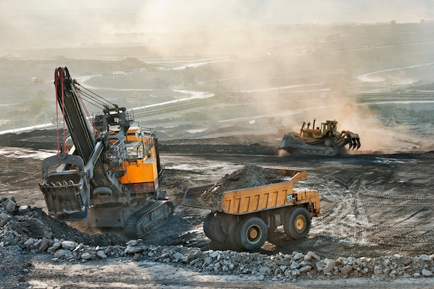 Photo coal mine area many heavy truck and excavator machine for mining industry