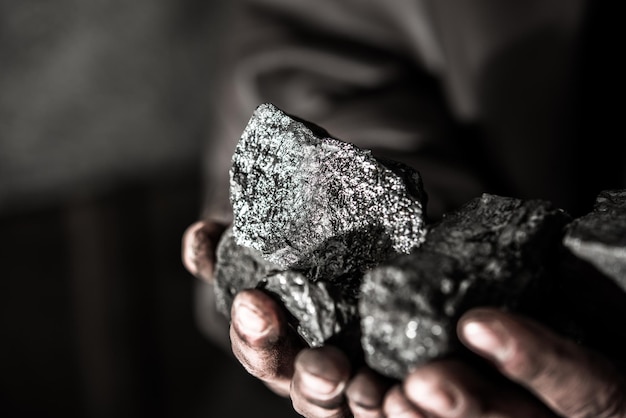 Coal mining coal miner in the man hands of coal background.\
picture idea about coal mining or ener