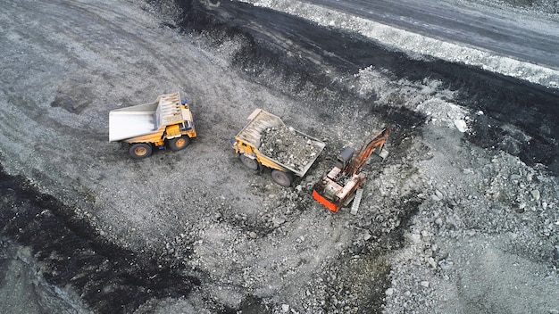 Coal mining in a quarry. A hydraulic excavator loads a dump truck.