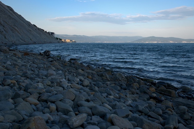 Coast of the Black Sea at sunset Summer late evening Beautiful seascape Blue sky steep cliffs endless sea Panoramic view Russia