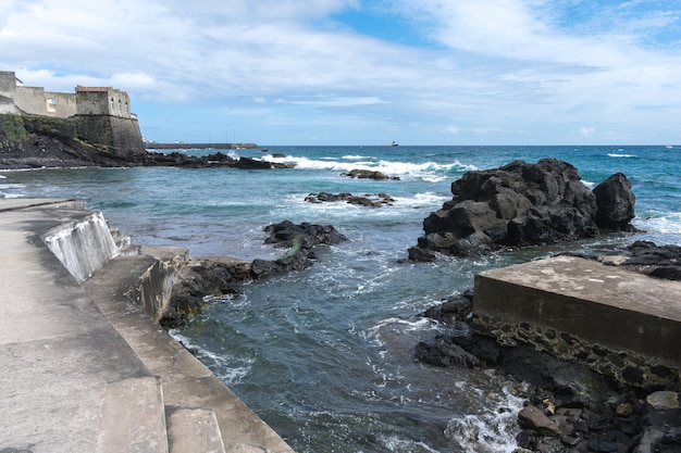 Coast rocks in azores. Waves splashing on basalt rocks