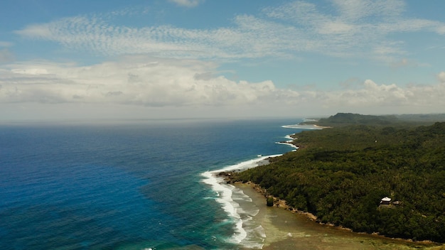 The coast of siargao island blue ocean and waves