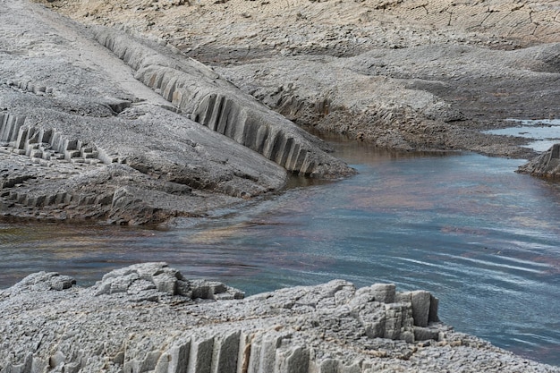 Coastal seascape with beautiful columnar basalt rocks at low tide