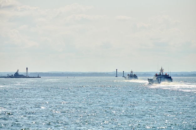 Coastguard, rescue and support patrol boats for defense sailing in blue sea. Navy patrol vessels protecting water borders and fisheries. Military ship, warship, battleship. Baltic Fleet, Russian Navy